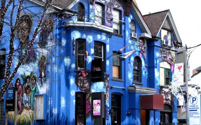 Crews and Tangos-resized Building with a bright blue mural depicting the history of drag in Toronto.