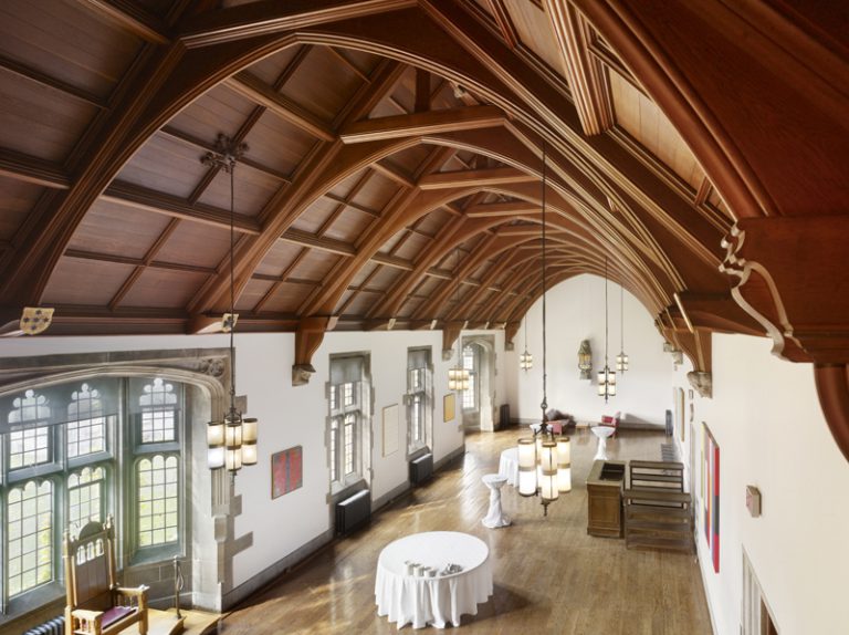 Debates room at Hart House, with high wood vaulted ceilings, wood floors. View is from above.