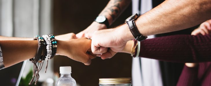 Hands coming together in symbol of teamwork