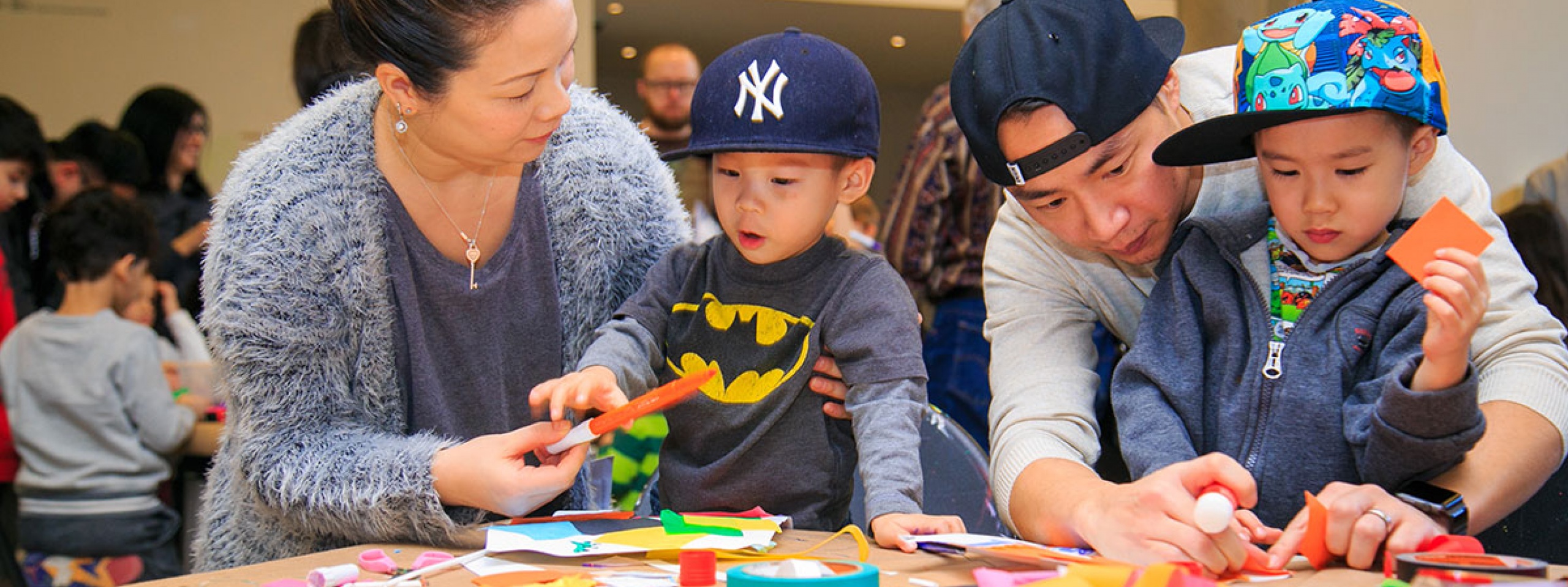 Parents help their kids with crafts at the AGO.