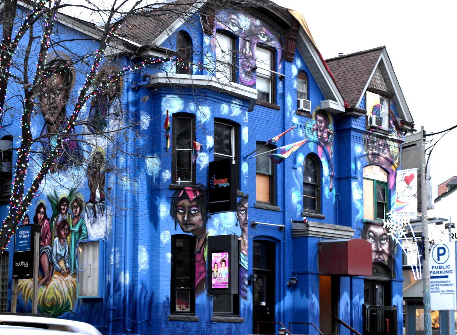 Building with a bright blue mural depicting the history of drag in Toronto.